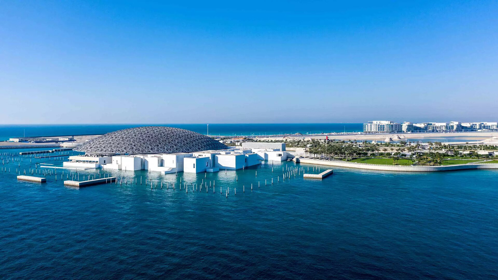 Saadiyat Island landmarks and amenities amidst water, buildings, trees, and sky