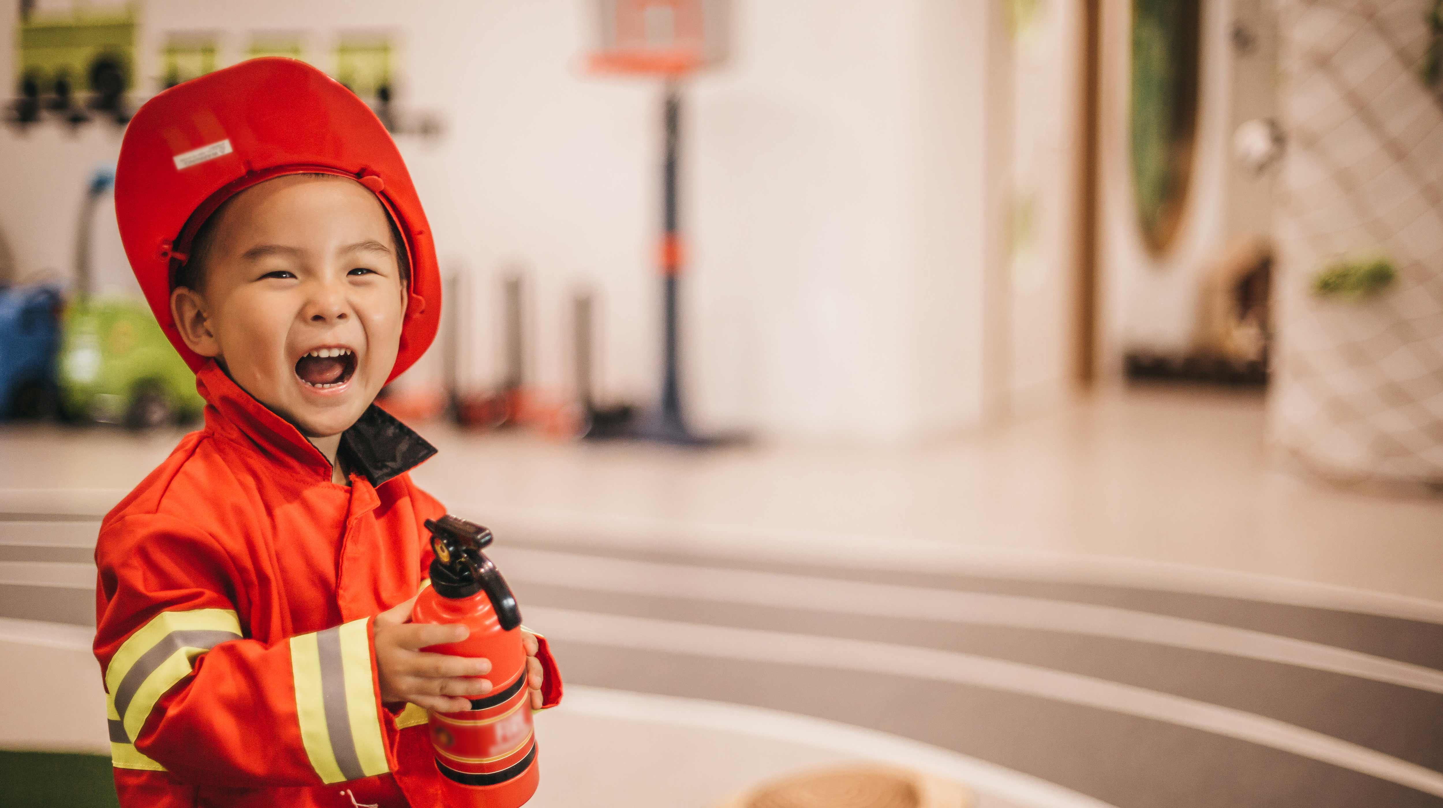 Young boy roleplaying a firefighter at Kidzania Abu Dhabi