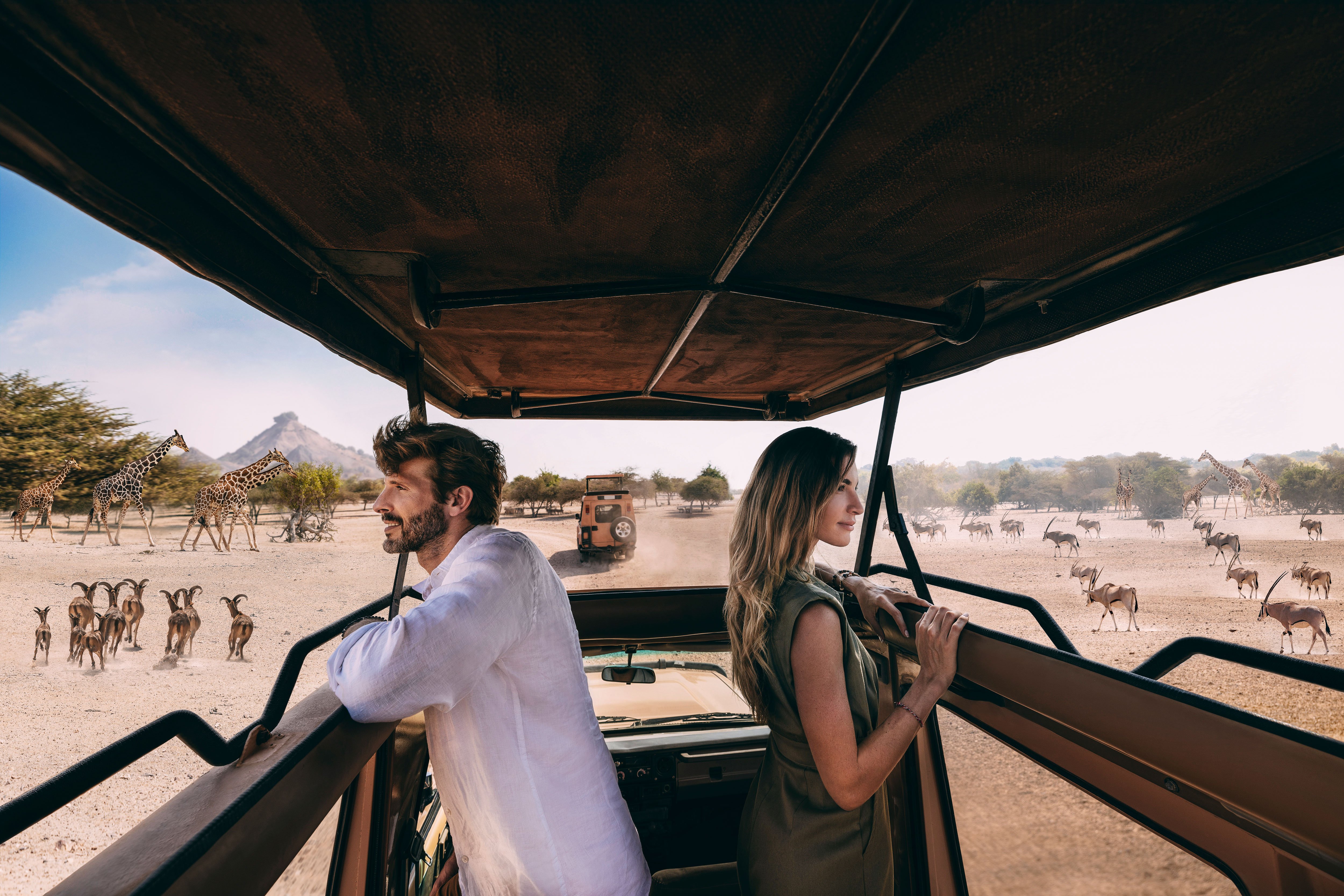 Western couple admiring wildlife on a safari in abu dhabi