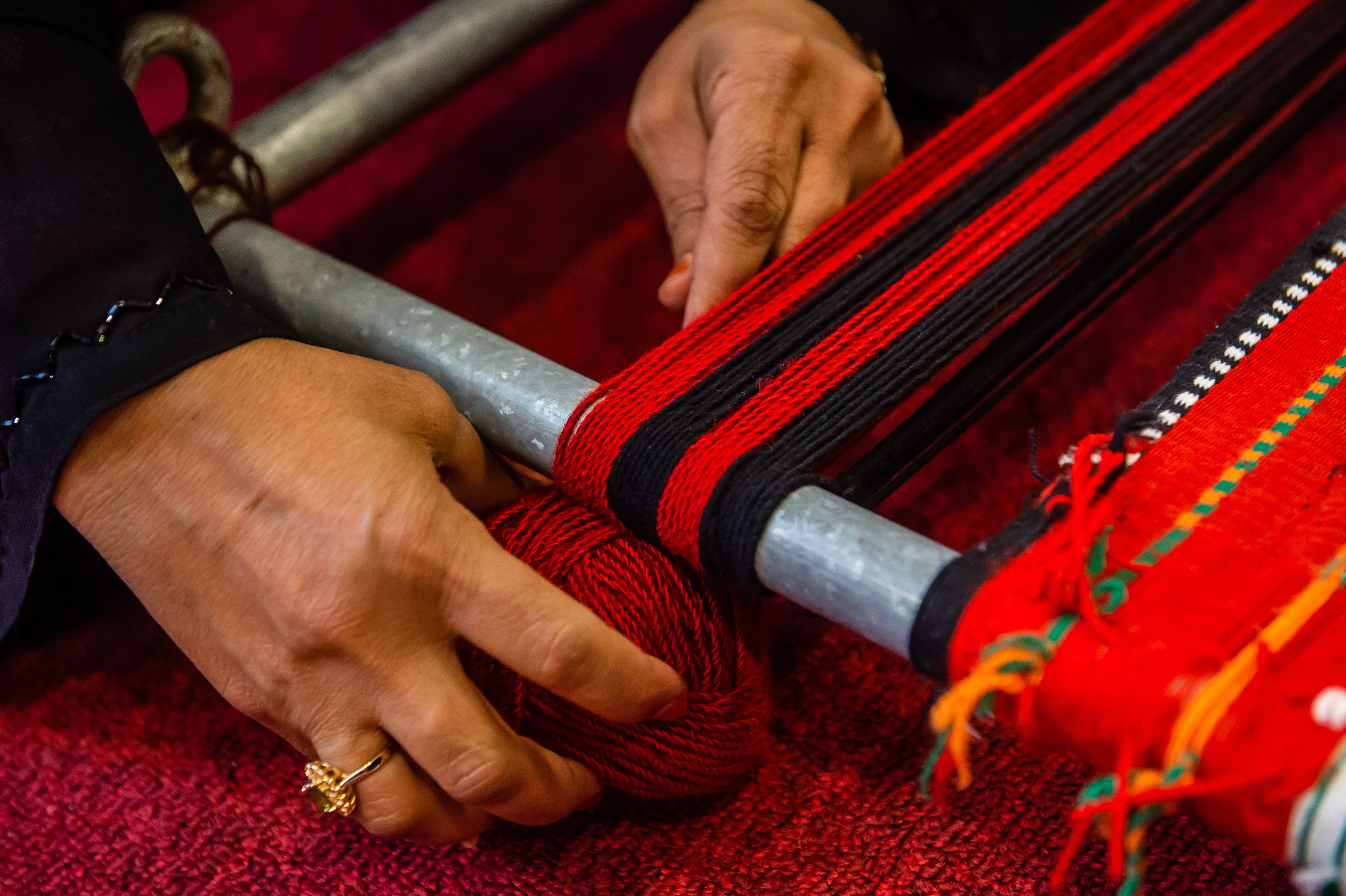 Emirati woman's hand weaving traditional Bedouin Sadu