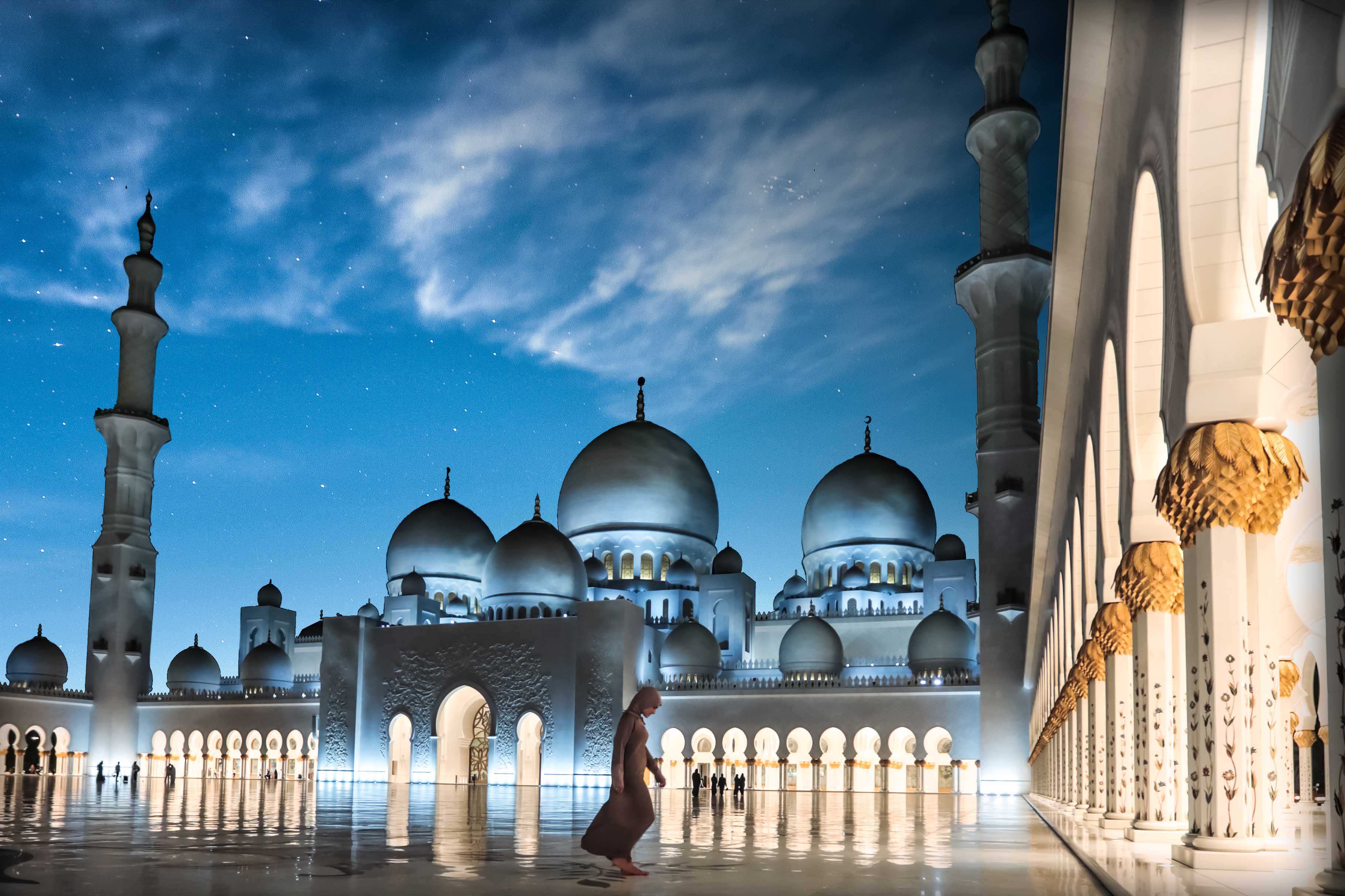 Woman outside Sheikh Zayed Grand Mosque at night