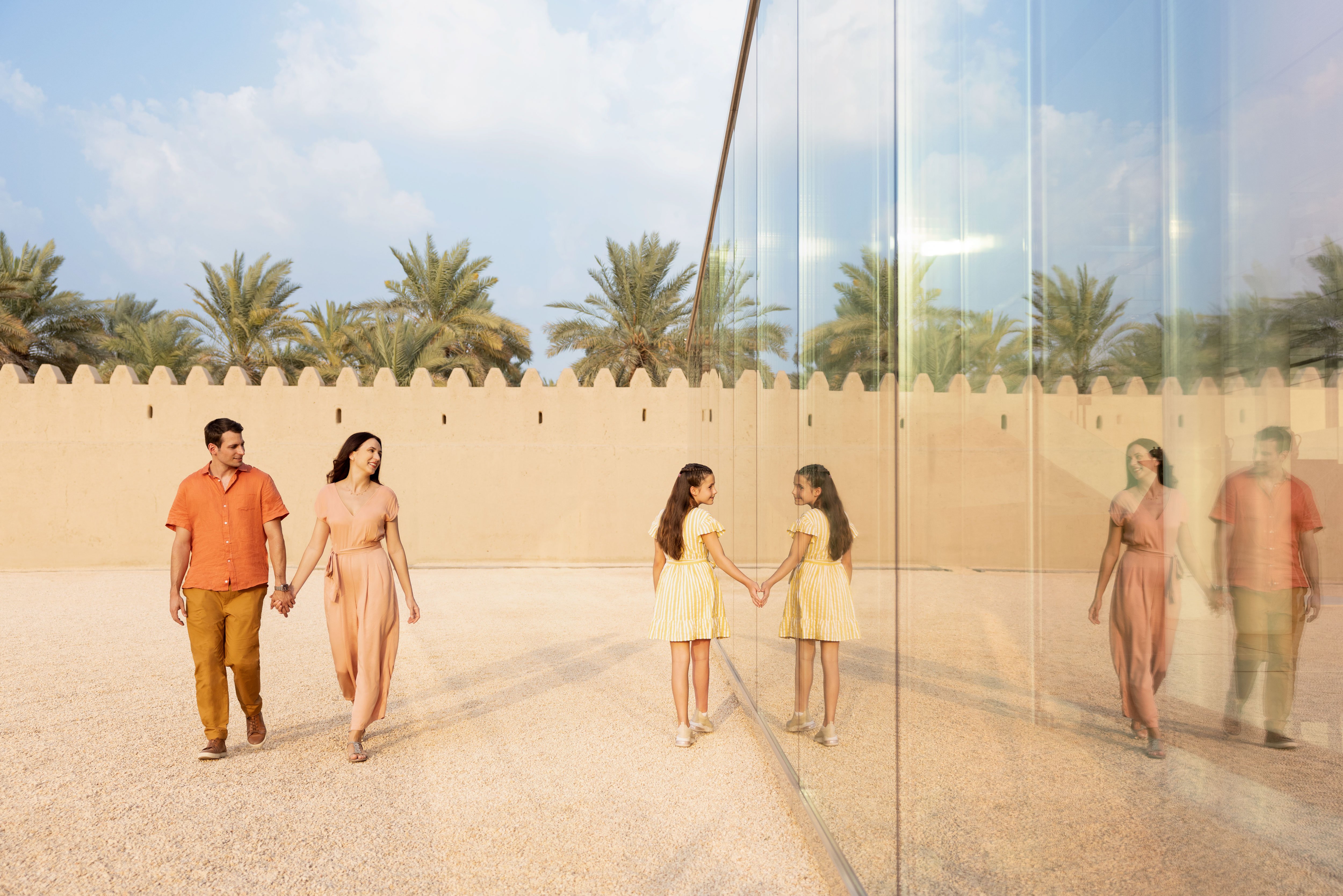 Western family of 3 enjoying exploring the ancient Qasr al Muwaiji