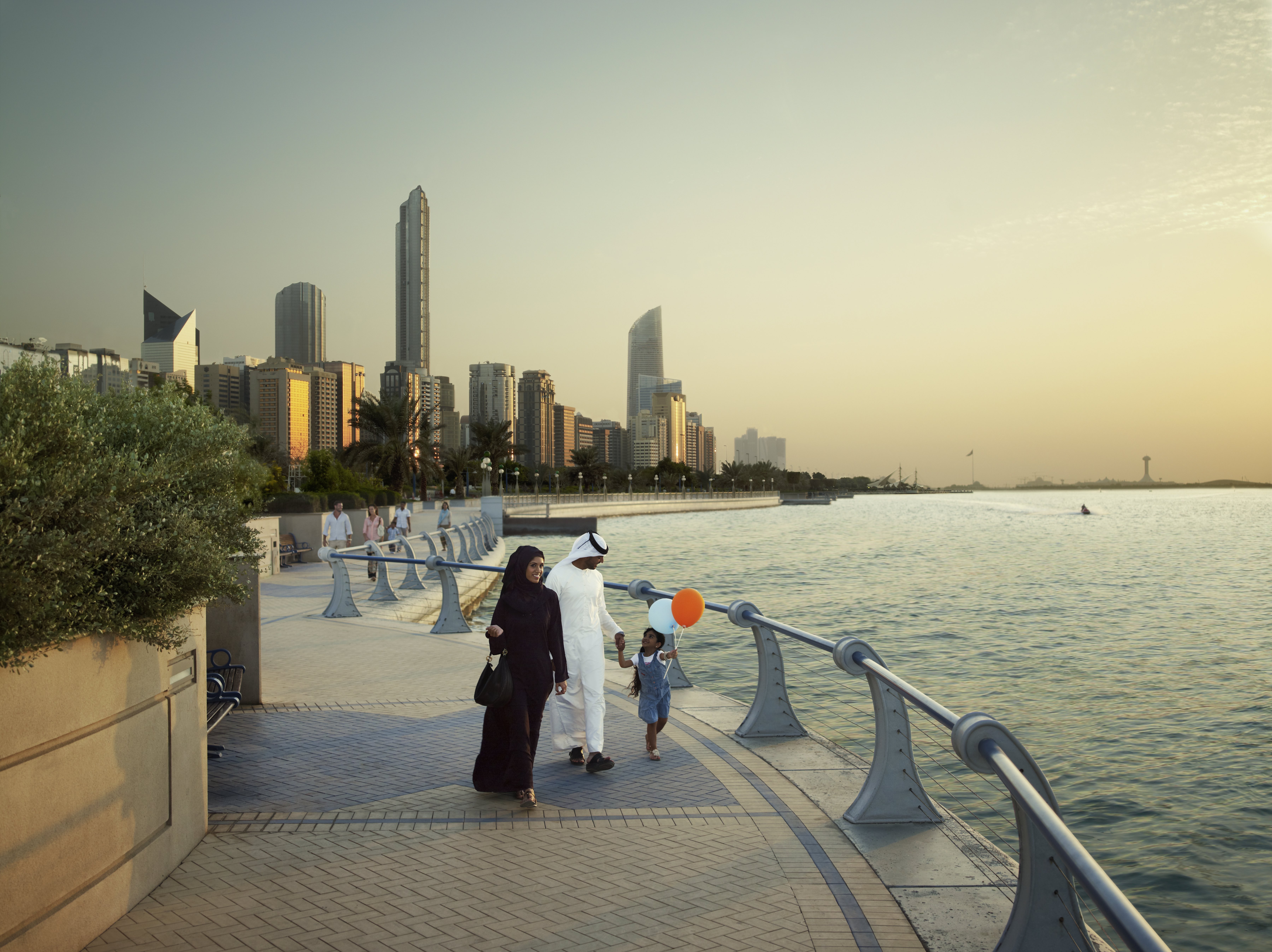 Emirati family walking along one of the promenades in Abu Dhabi