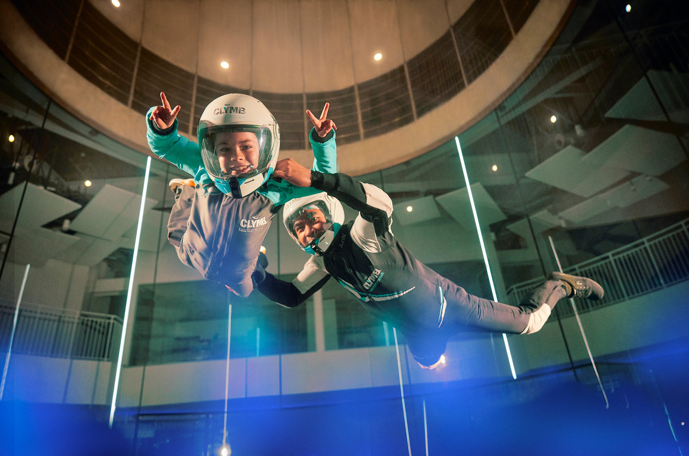 Girl and guide flying in the wind tunnel at Clymb