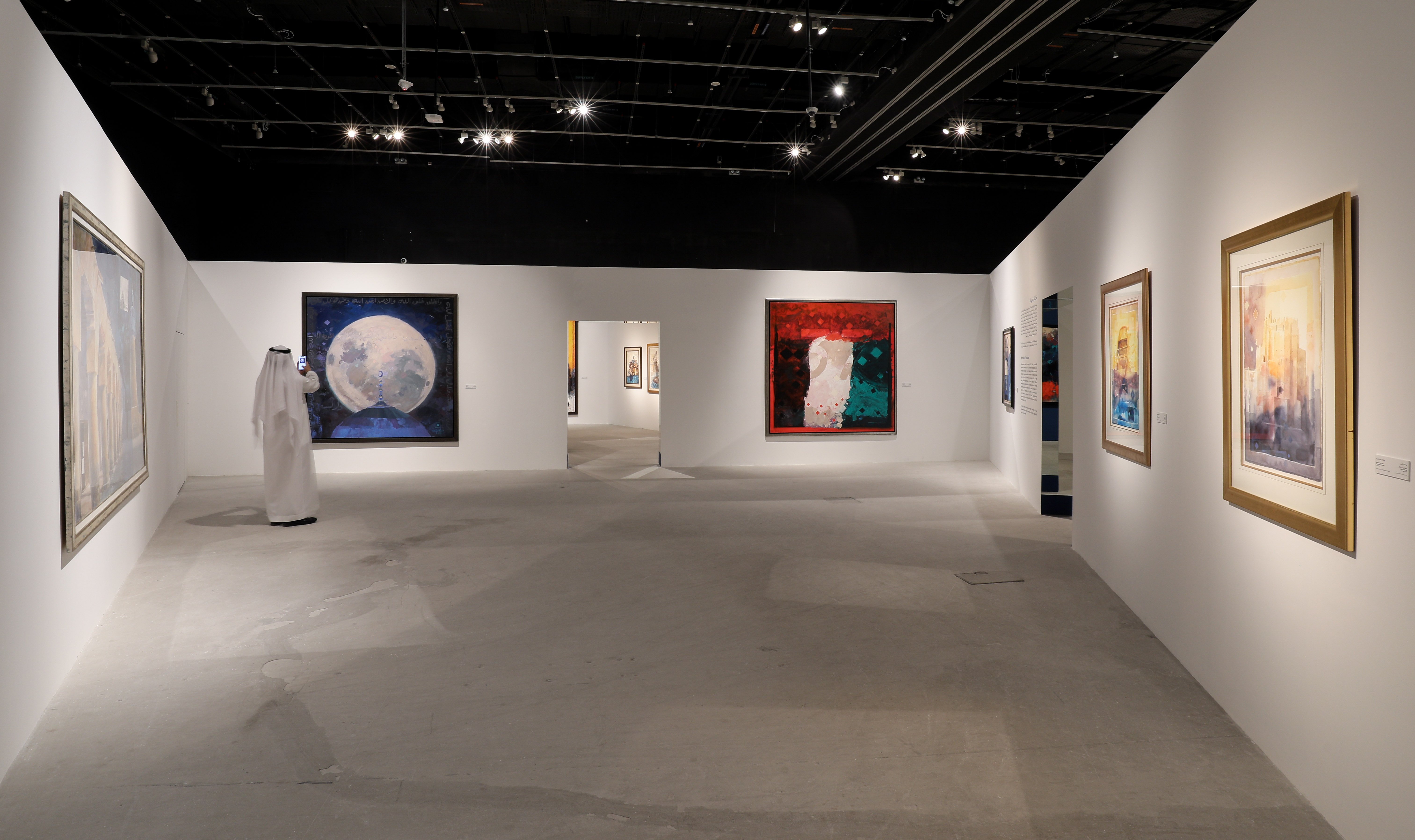 Emirati man taking images of artwork at an art gallery in Manarat Al Saadiyat